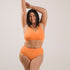 Sustainable, ethically produced mandarin wireless bra by Underwear for Humanity. A -D cup sizes. Recycled materials, flexible, supportive. Knitted bra and band, adjustable straps. Models wear the A-D bra.
