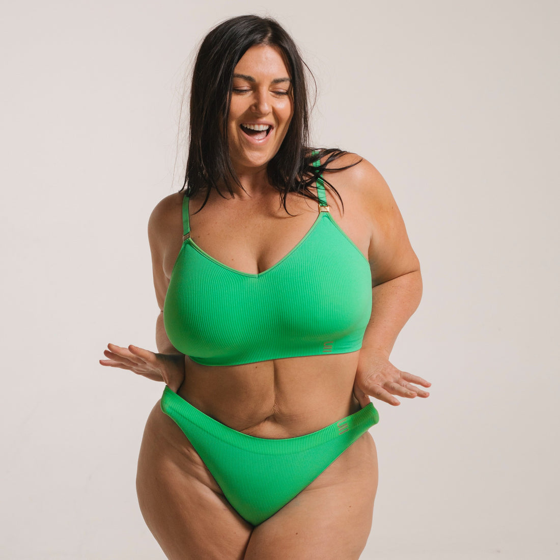 Ethically made recycled seam free apple bikini brief by Underwear for Humanity: Flexible and comfortable, stretches across sizes. Models wear bikini brief underwear. Underwear is made from recycled nylon and sits low on the waist, full seat coverage and smooth on the body.