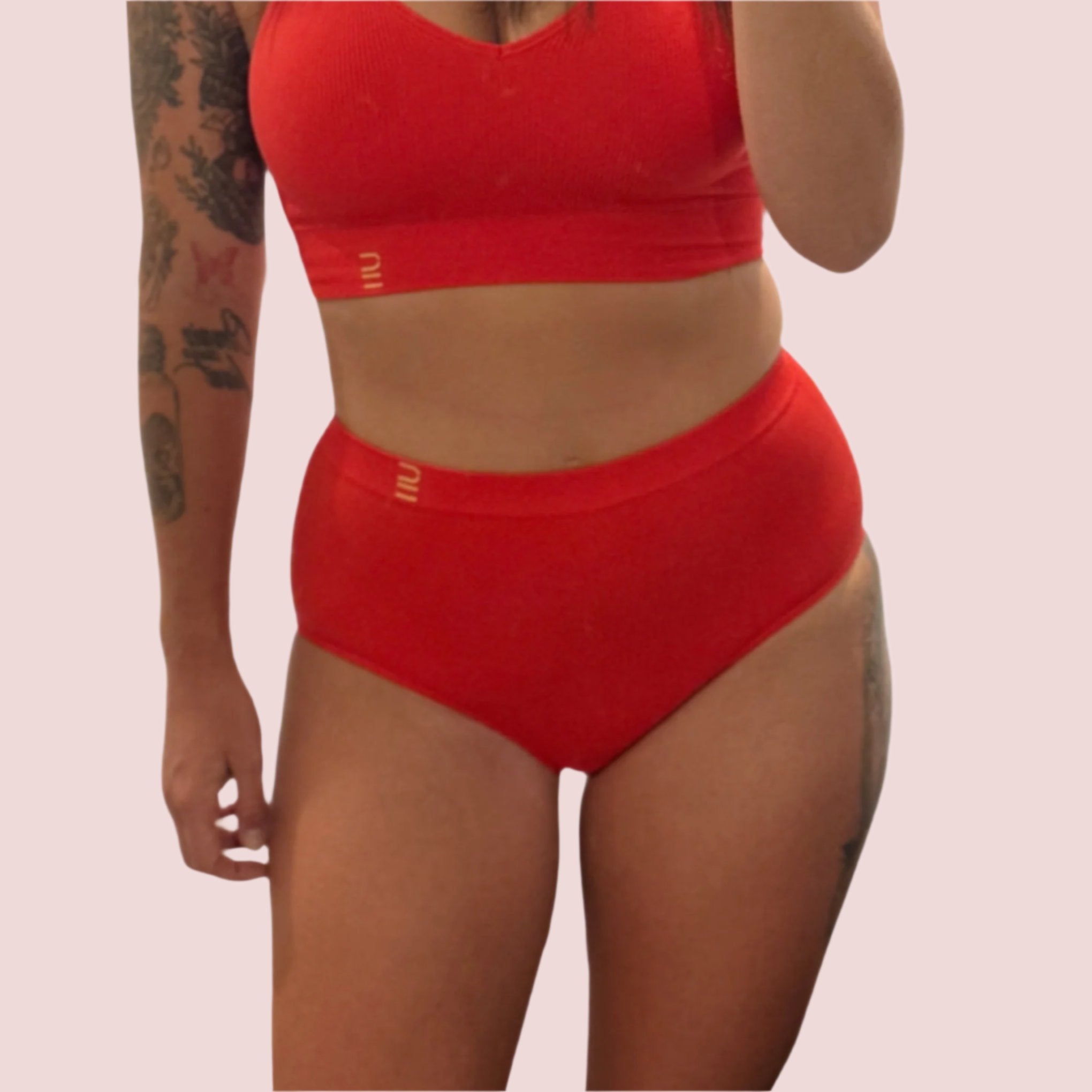 Sustainable red high waist brief by Underwear for Humanity: ethical, sustainable. sizes 6-30 light, breathable. Models wear high-waisted underwear. underwear sits high on the waist, full seat coverage. smooth under clothing. made from Tencel and recycled materials, attached no-dig recycled elastic waist band.