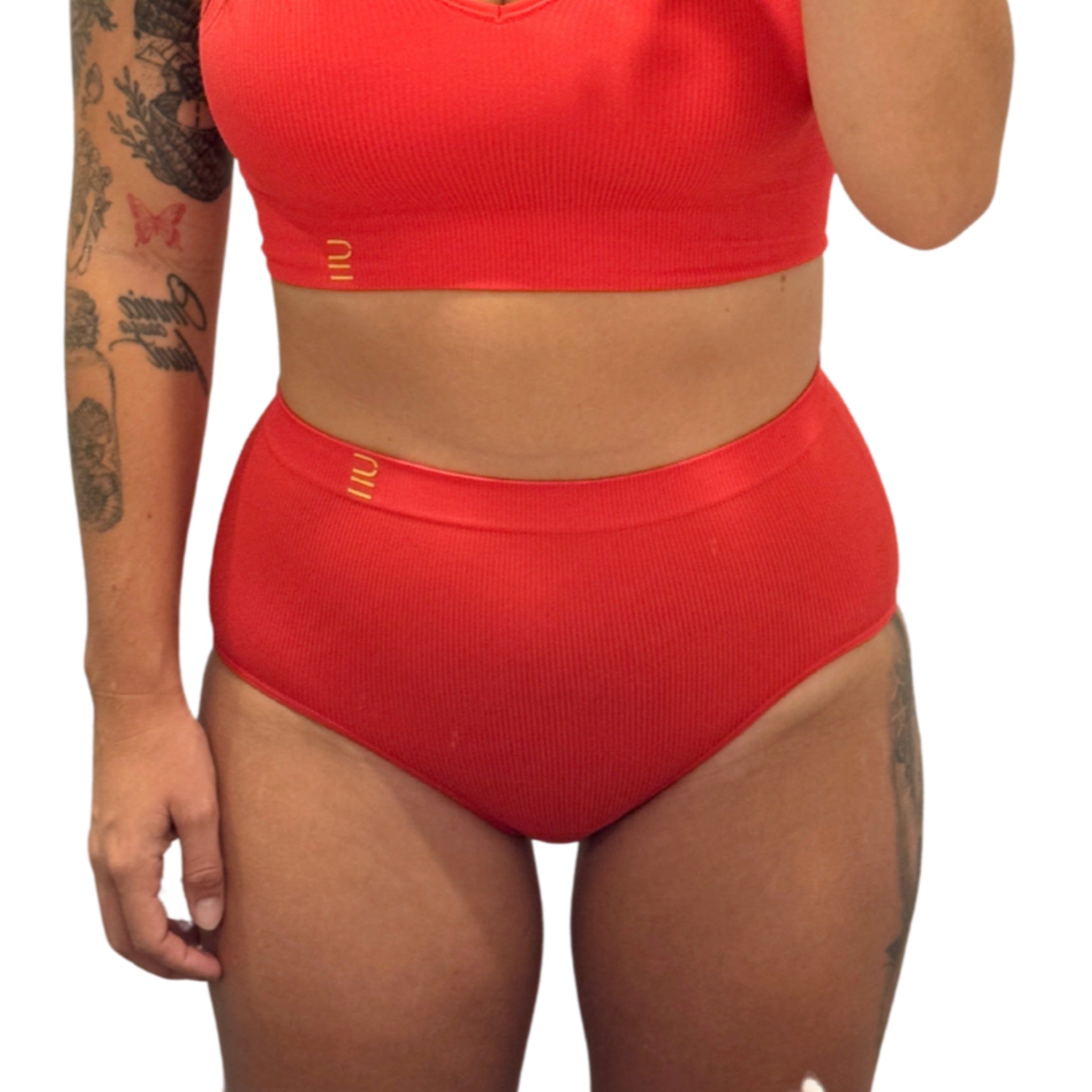 Sustainable red high waist brief by Underwear for Humanity: ethical, sustainable. sizes 6-30 light, breathable. Models wear high-waisted underwear. underwear sits high on the waist, full seat coverage. smooth under clothing. made from Tencel and recycled materials, attached no-dig recycled elastic waist band.