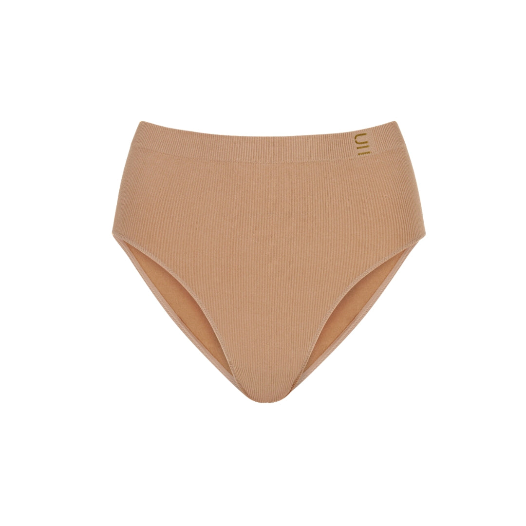 A front view of the recycled nylon seamfree brief in nude 4. sustainable and ethically made.