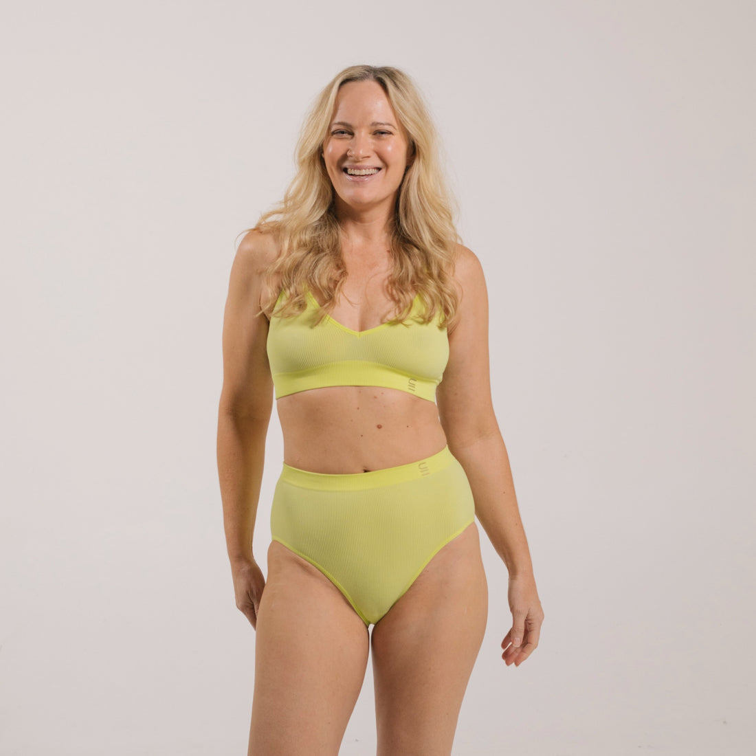 Sustainable, ethically produced lime wireless bra by Underwear for Humanity. A -D cup sizes. Recycled materials, flexible, supportive. Knitted bra and band, adjustable straps. Models wear the A-D bra.