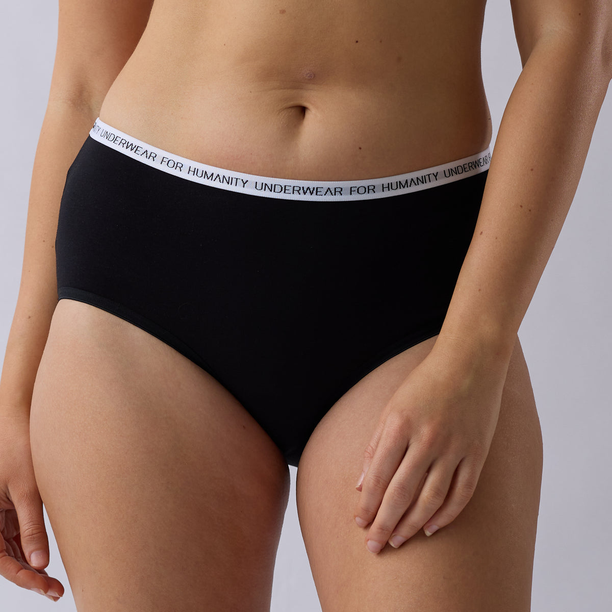 Underwear for Humanity Organic Cotton Midi Brief in Black, a lower-rise women’s underwear style with a lower-cut leg, soft breathable fabric and comfortable everyday coverage