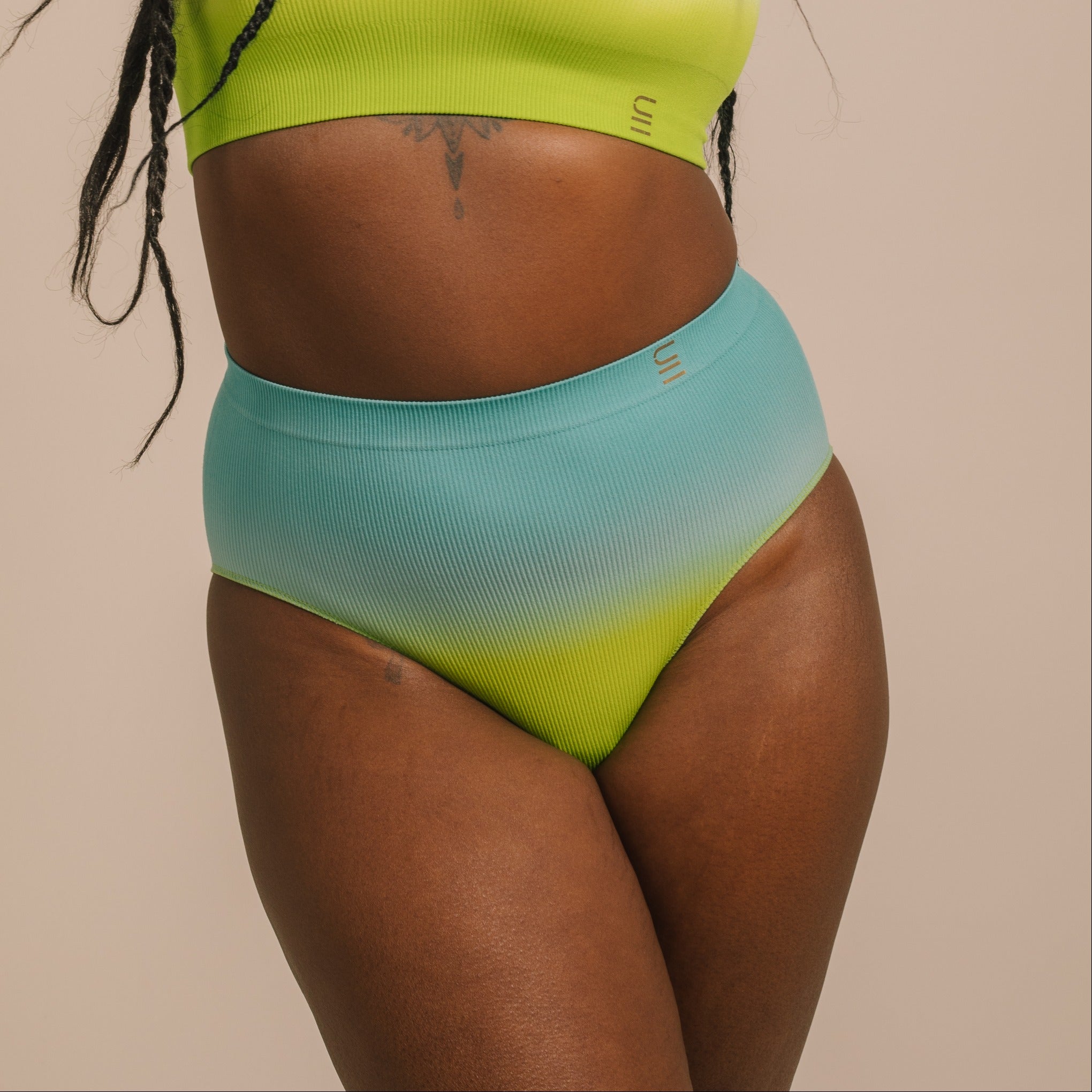 Sustainable, ethically made ocean high waist seam free brief by Underwear for Humanity: Flexible and comfortable, stretches across sizes. Models wear high waisted ethical underwear. Underwear is made from recycled nylon and sits high on the waist, full seat coverage and smooth on the body.