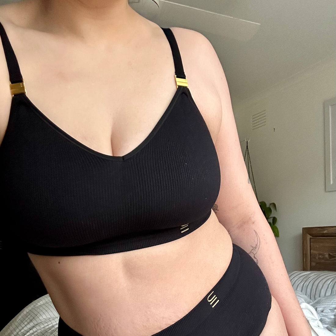 Sustainable black wireless maternity bra by Underwear for Humanity: ethical, sustainable. A -D and DD-GG cup sizes. Recycled materials, flexible, supportive, pregnancy, feeding, convertible. Knitted bra and band, adjustable straps. Models showcases maternity bra