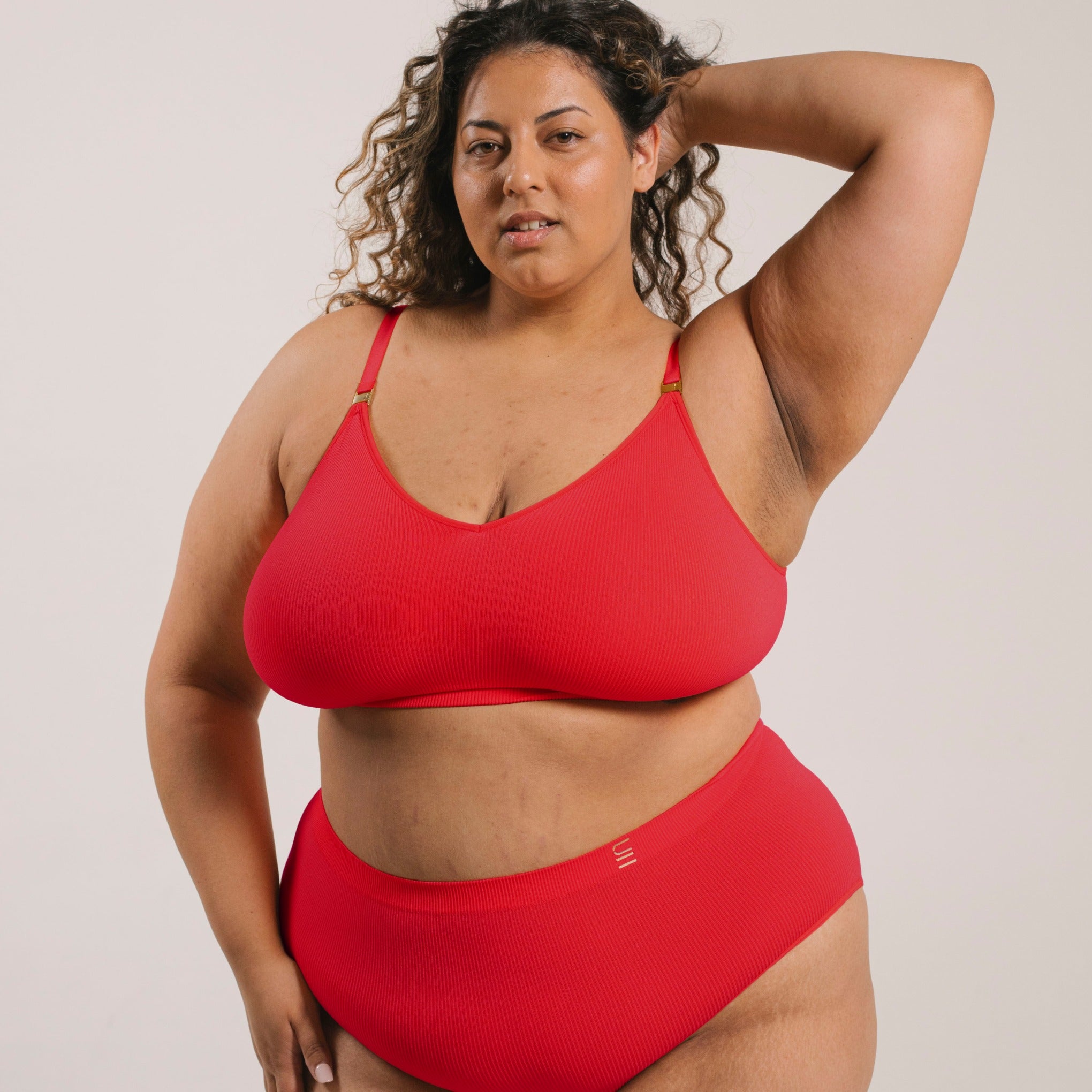 Sustainable red high waist brief by Underwear for Humanity: ethical, sustainable. sizes 6-30 light, breathable. Models wear high-waisted underwear. underwear sits high on the waist, full seat coverage. smooth under clothing. made from Tencel and recycled materials, attached no-dig recycled elastic waist band.