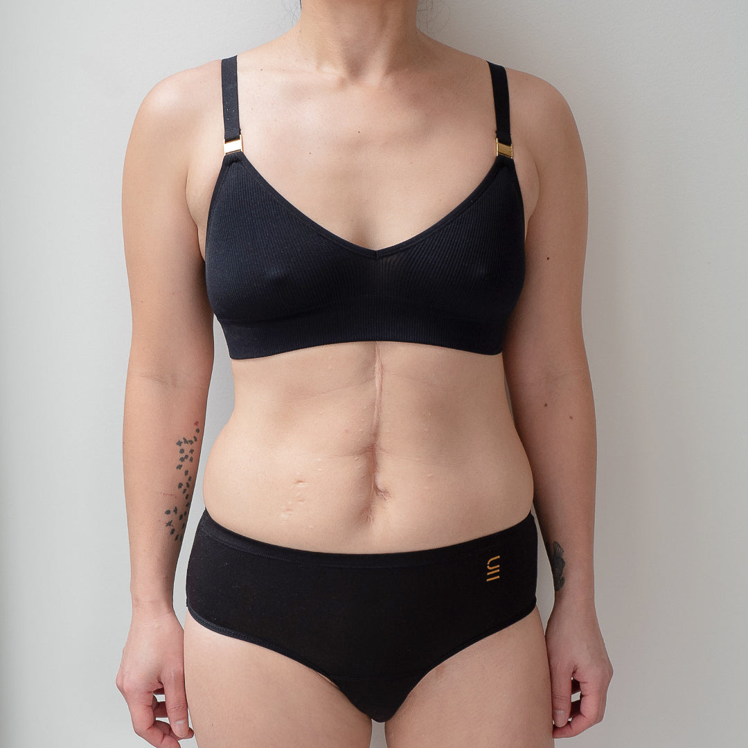 Sustainable, ethically made black wee or period undies. Absorbent without bulk. 1 day worth of wear or 3 tampons worth of protection. Suitable for day time use only. Toxin free, naturally antibacterial. Model wears daytime wee or period undies.