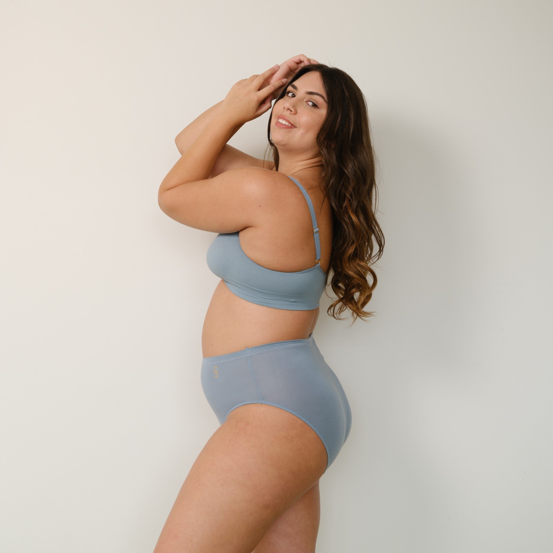 Sustainable mineral blue high waist brief by Underwear for Humanity: ethical, sustainable. sizes 6-26. light, breathable. Models wear high-waisted underwear. underwear sits high on the waist, full seat coverage. smooth under clothing. made from Tencel and recycled materials