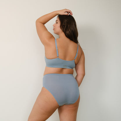 Sustainable mineral blue high waist brief by Underwear for Humanity: ethical, sustainable. sizes 6-26. light, breathable. Models wear high-waisted underwear. underwear sits high on the waist, full seat coverage. smooth under clothing. made from Tencel and recycled materials