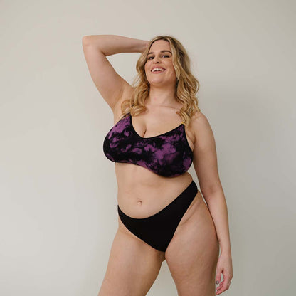 Sustainable black high waist g-string by Underwear for Humanity: ethical, sustainable. sizes 6-26. Models wear high-waisted G -string underwear. underwear sits high on the waist, sits smooth on the body, made from Tencel and recycled materials.