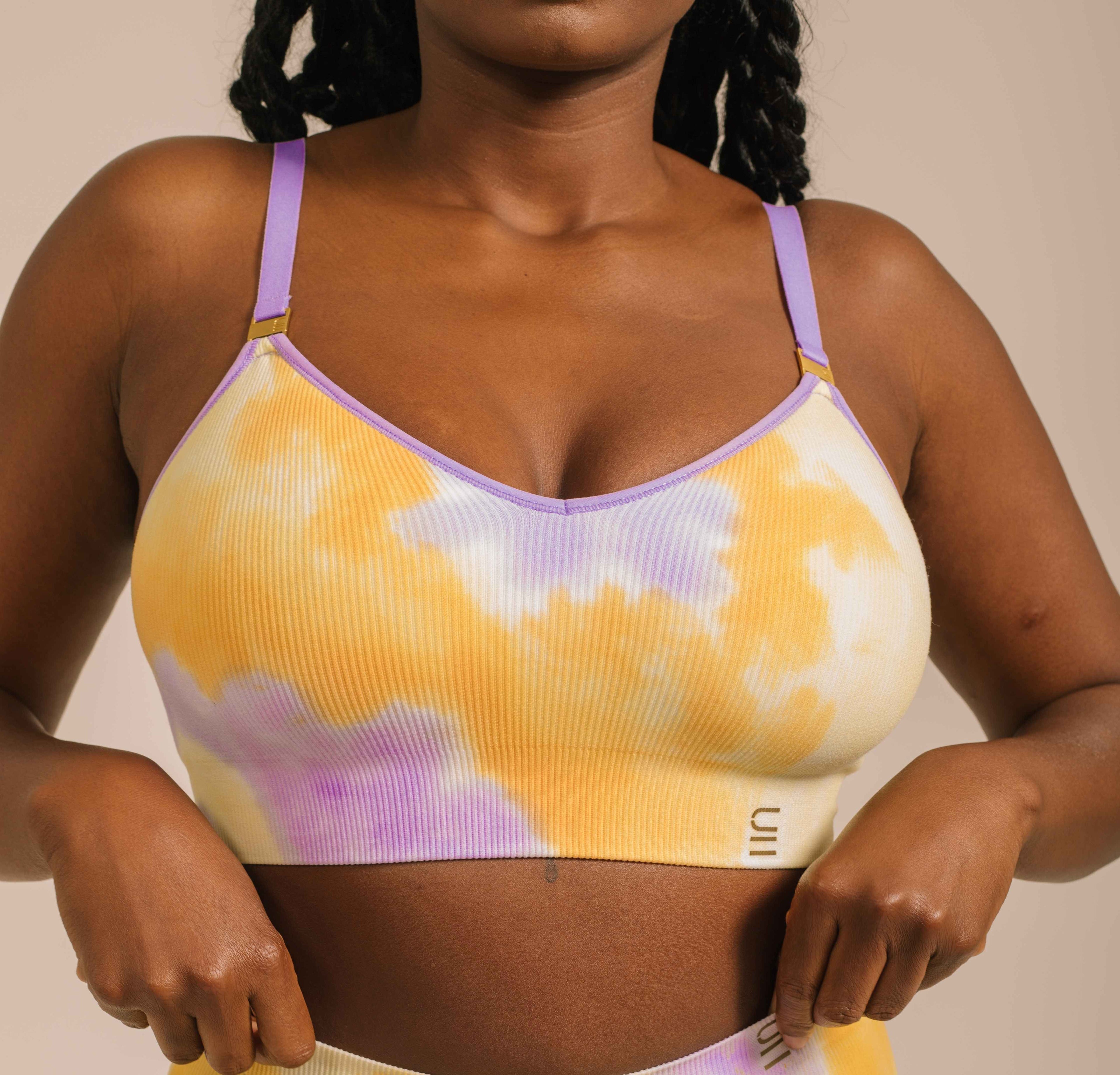 Sustainable sunrise yellow and purple tie dye wireless bra by Underwear For Humanity: ethical, sustainable. A -D cup sizes. Recycled materials, flexible, supportive. Knitted bra and band, adjustable straps. Models show case A-D bra