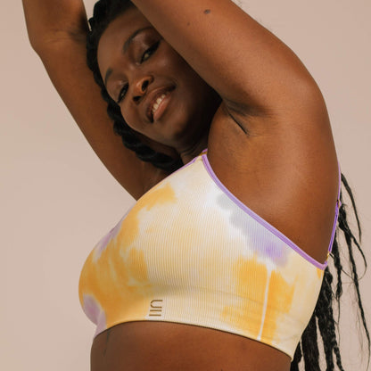 Sustainable, ethically produced sunrise - yellow, orange and purple tie dye wireless bra by Underwear for Humanity. A -D cup sizes. Recycled materials, flexible, supportive. Knitted bra and band, adjustable straps. Models wear the A-D bra.