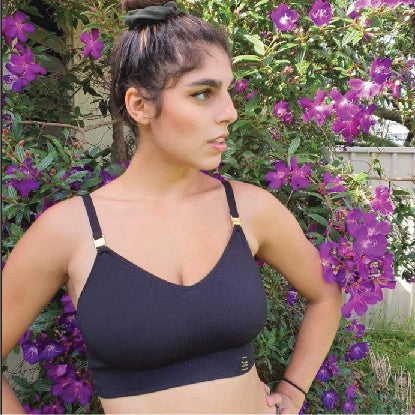Sustainable, ethically produced black wireless bra by Underwear for Humanity. For DD-GG cup sizes. Recycled materials, flexible, supportive. Knitted bra and band, adjustable straps. Model wears the DD+ bra.
