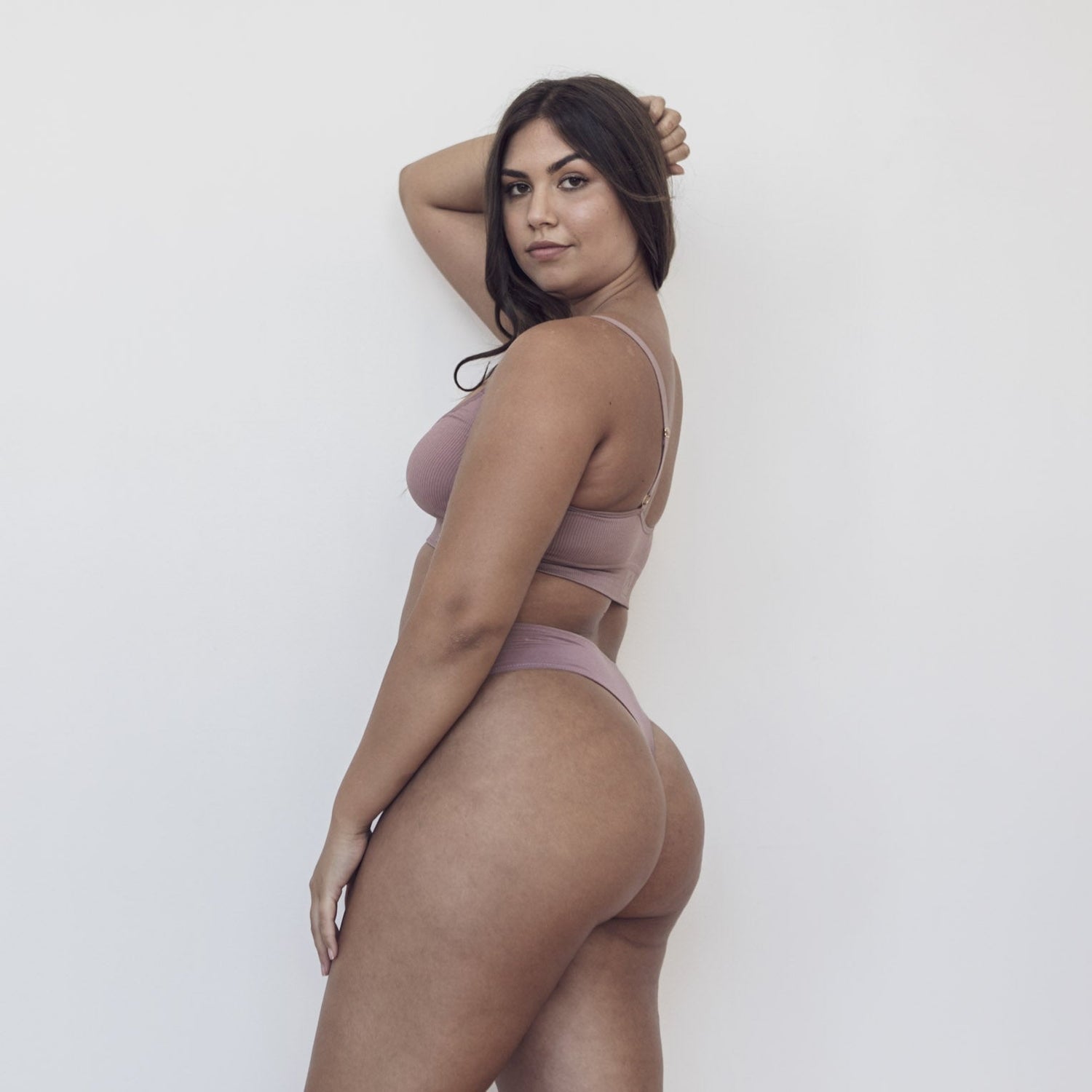 Sustainable bruised mauve high waist g-string by Underwear for Humanity: ethical, sustainable. sizes 6-26. Models wear high-waisted G -string underwear. underwear sits high on the waist, sits smooth on the body, made from Tencel and recycled materials.