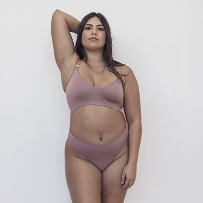 Sustainable bruised mauve high waist g-string by Underwear for Humanity: ethical, sustainable. sizes 6-26. Models wear high-waisted G -string underwear. underwear sits high on the waist, sits smooth on the body, made from Tencel and recycled materials.