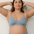 Sustainable mineral blue wireless bra by Underwear For Humanity: ethical, sustainable. A -D cup sizes. Recycled materials, flexible, supportive. Knitted bra and band, adjustable straps. Model showcases A-D bra