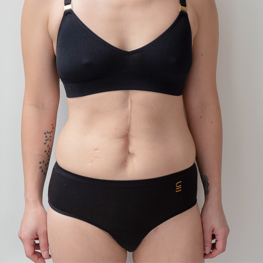 Sustainable, ethically made black wee or period undies. Absorbent without bulk. 1 day worth of wear or 3 tampons worth of protection. Suitable for day time use only. Toxin free, naturally antibacterial. Model wears daytime wee or period undies.